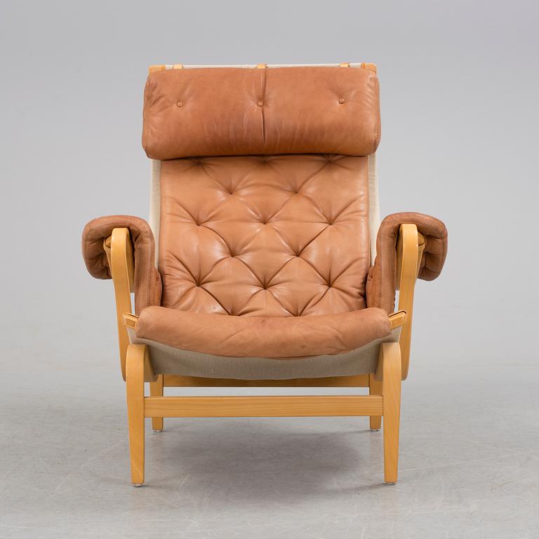A Bruno Mathsson 'Pernilla' beech, canvas and brown leather easy chair, DUX, Sweden.