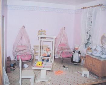 A doll house with interior and dolls ca 1910.