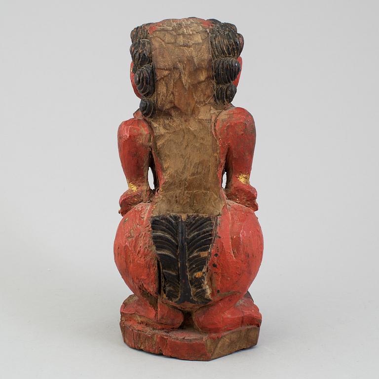 A wooden sculpture of a deity, India, circa 1900.