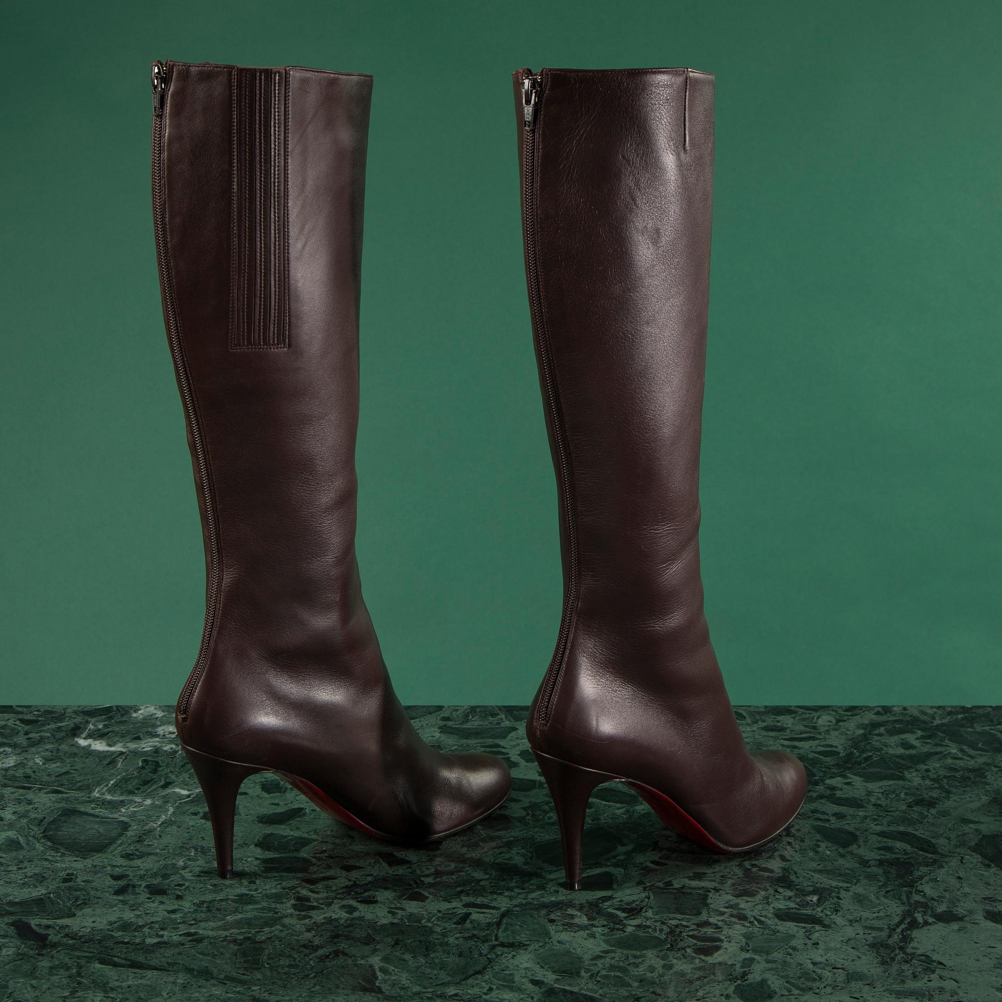 A pair of brown leather boots by Christian Louboutin, size 41 1/2.