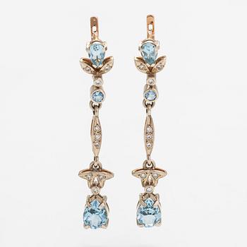 A pair of 14K gold earrings with diamonds ca. 0.18 ct in total and topazes.