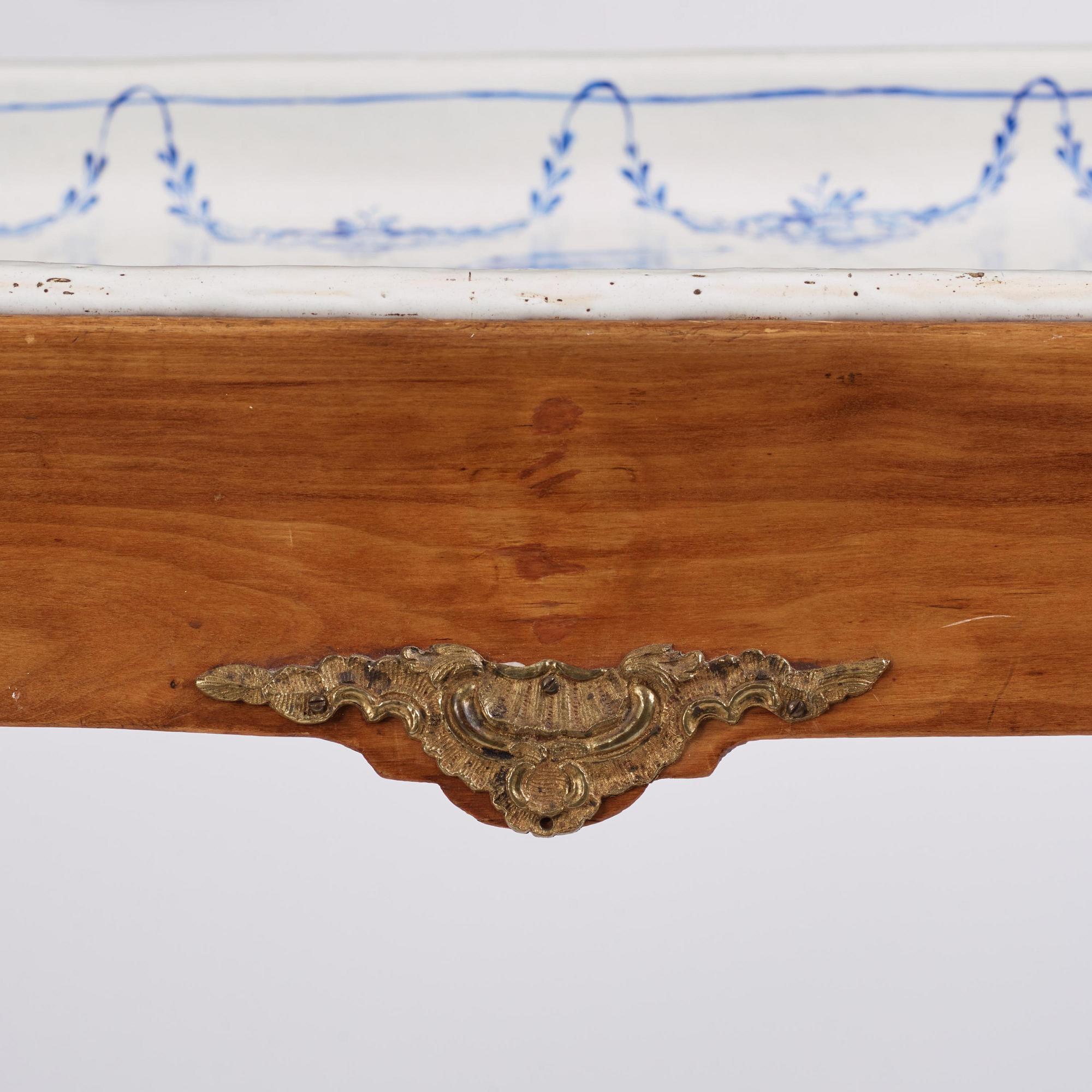 A rococo faience-top tea table, Rörstrand 1765.