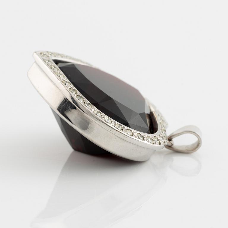 Heart shaped large garnet and round brilliant cut diamond pendant.
