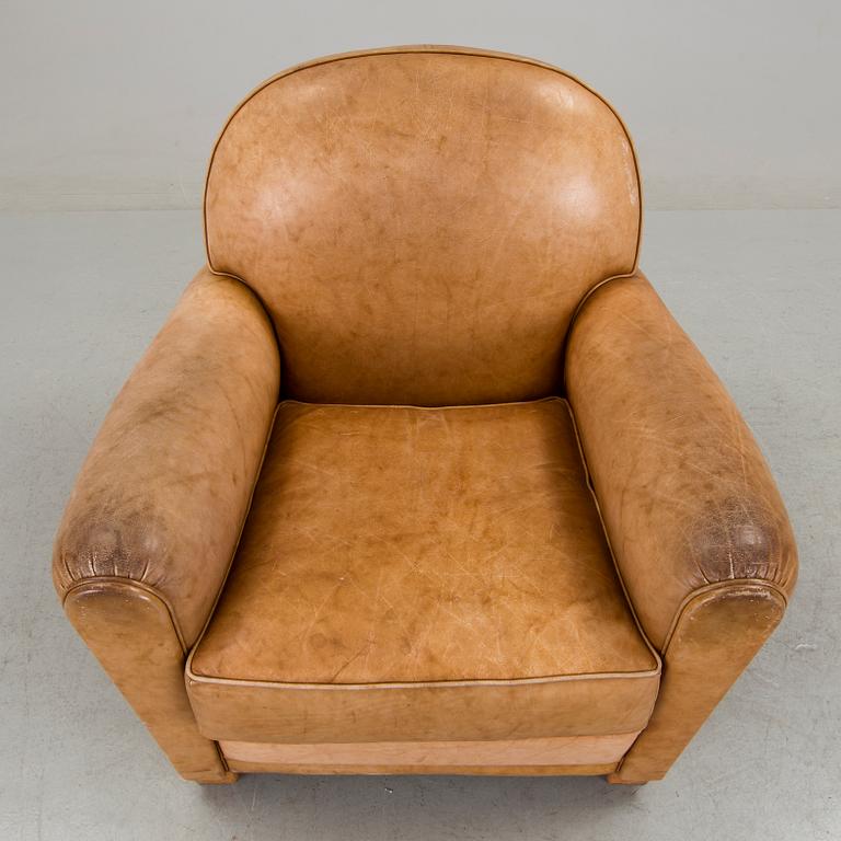 A brown leather armchair by grange, the second half of the 20th century.