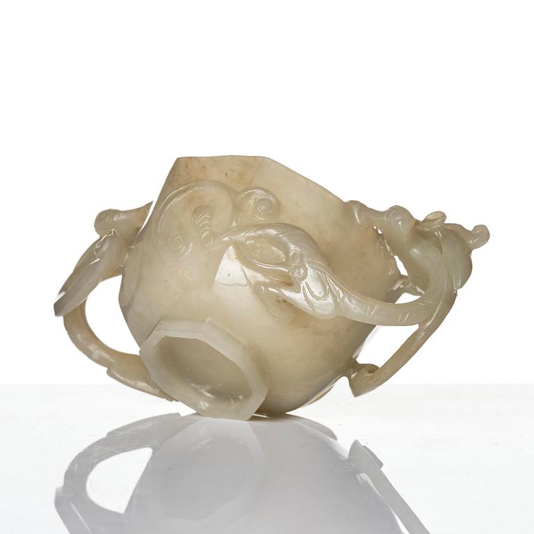 A carved nephrite cup with 'chilong' handles, late Qing dynasty/early 20th century.
