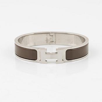 Hermès, a 'Clic H' bracelet.