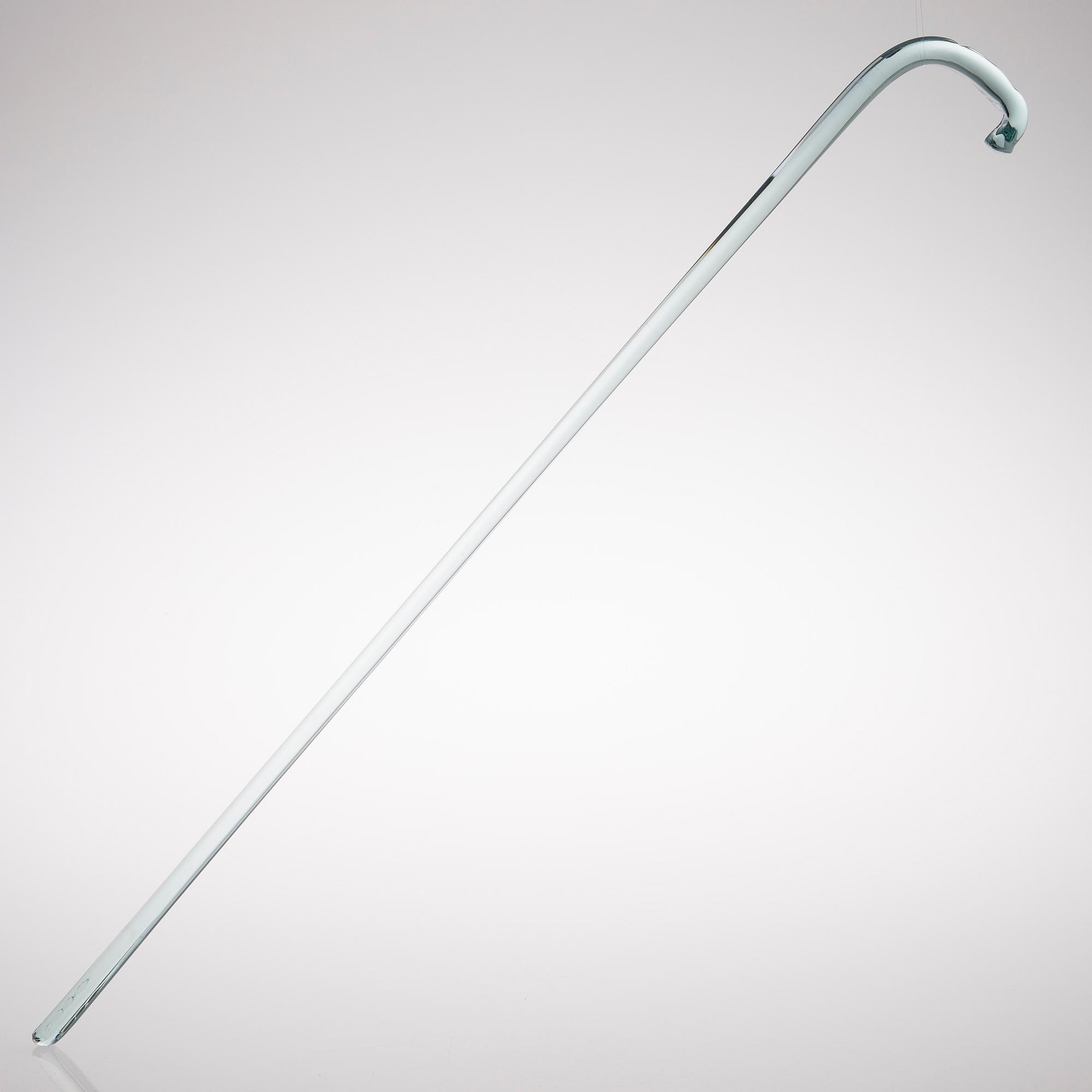 A greenish glass walking stick.
