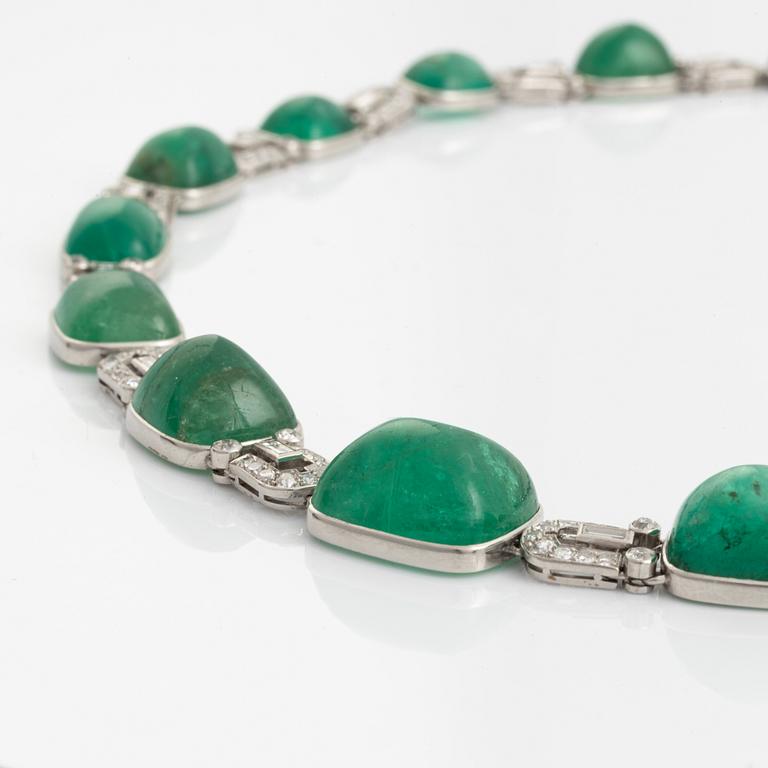 An art deco platinum necklace/bracelet combination with cabochon-cut emeralds.