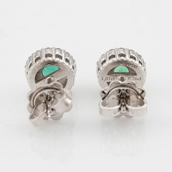 A pair of 18K gold earrings with faceted emeralds and round brilliant-cut diamonds.