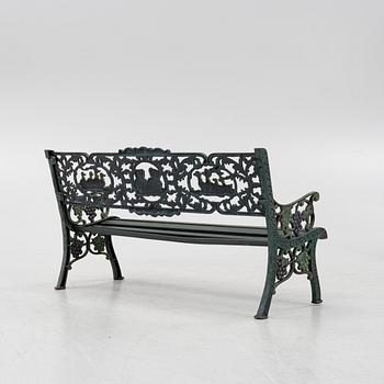 A children's cast iron garden sofa and armchair, mid 20th century.