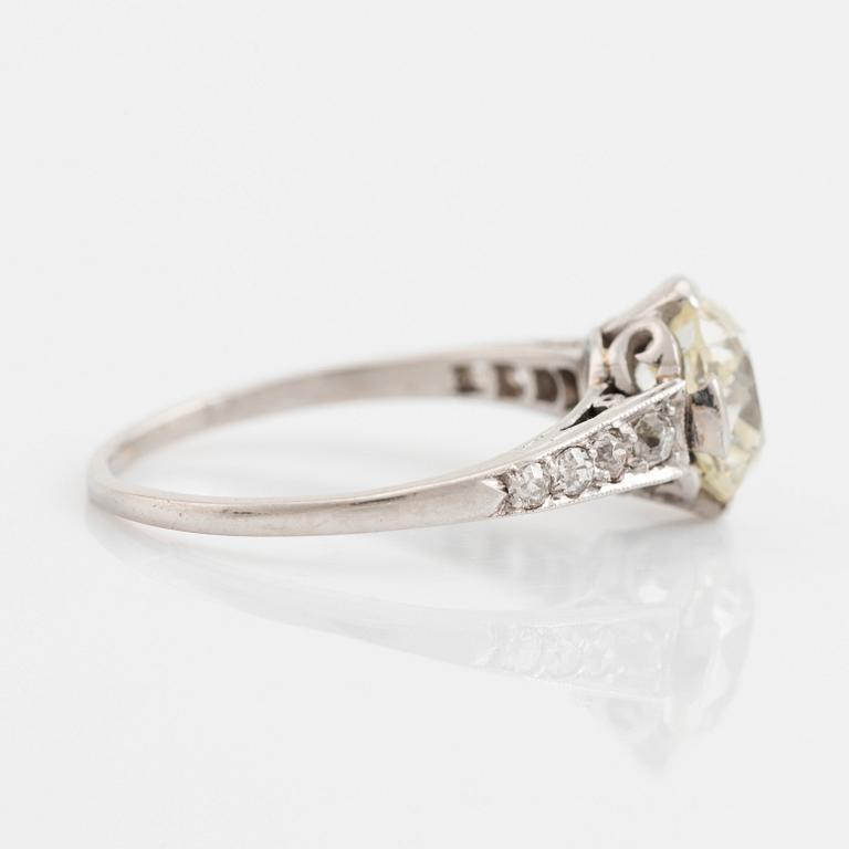 A platinum ring set with a cushion-formed old-cut diamond.