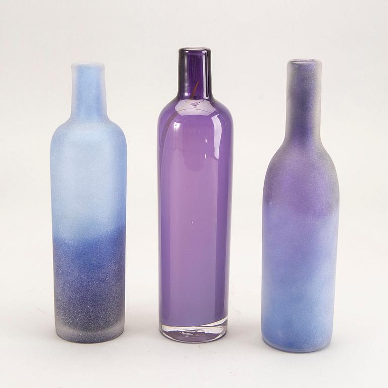 A set of three glass bottles Österlens glashytta 21st century.