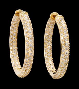 693. a pair of gold and diamond earrings.