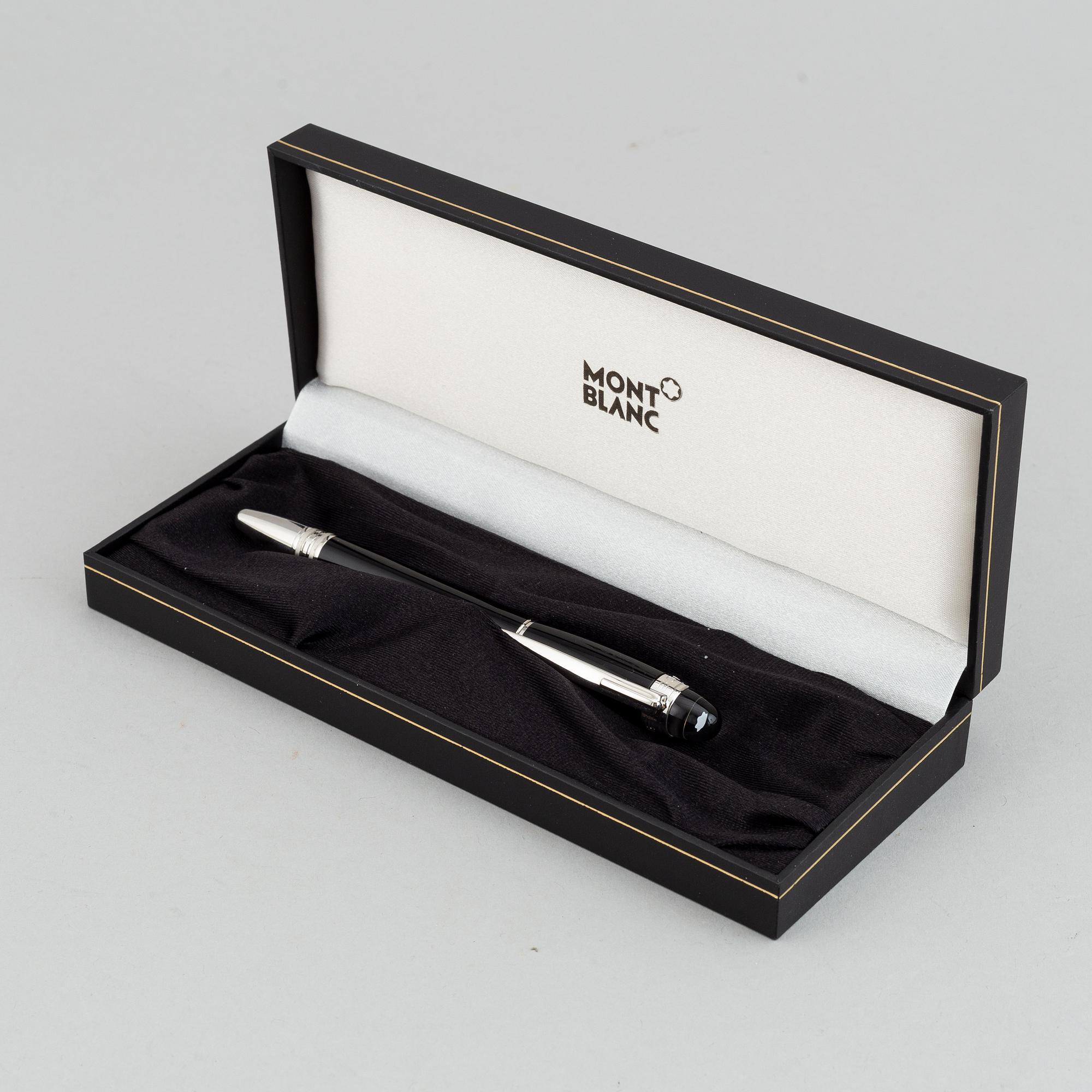 MOntblanc, a ball point pen and leather passport holder.