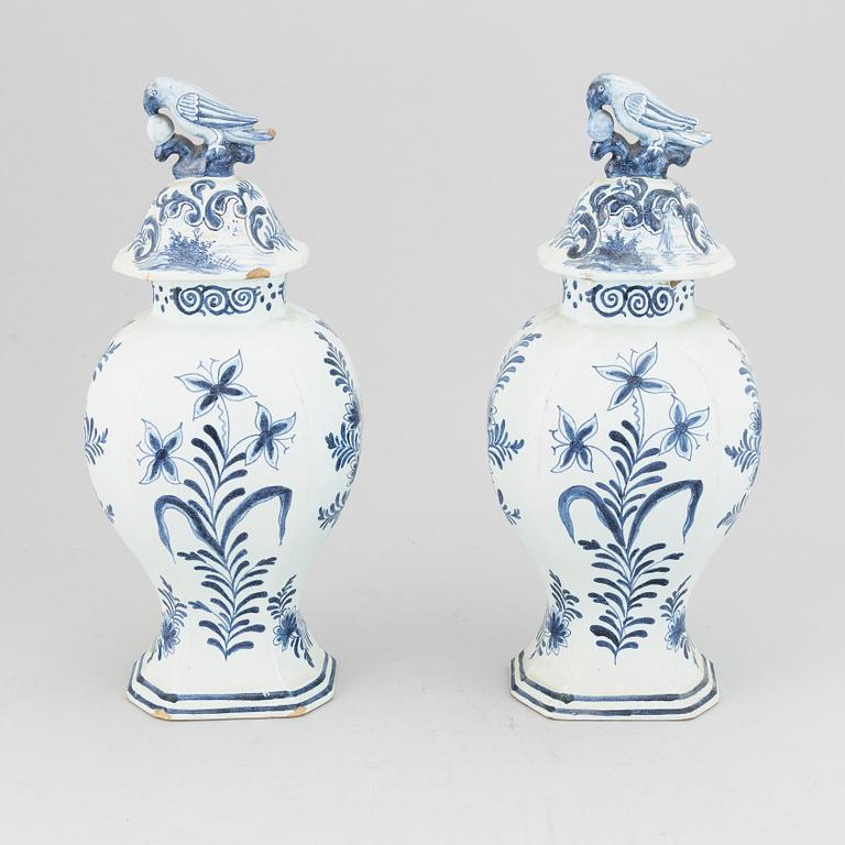 A pair of 19th century blue/white faience lidded jars, probably Dutch.