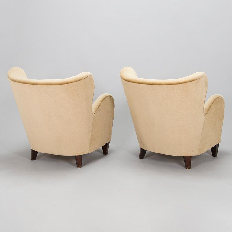 A pair of mid-20th century armchairs.