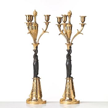 A pair of French Empire early 19th century three-light candelabra.