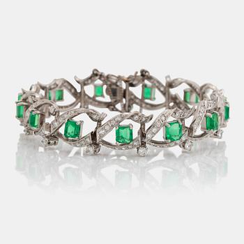 954. A platinum bracelet set with step-cut emeralds with a total weight of ca 12.50 cts.