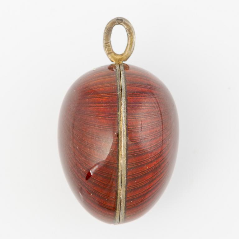 Pendant in the shape of an egg, silver with red enamel.