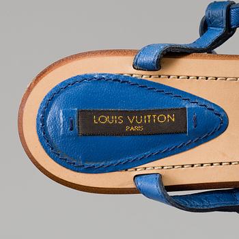 A pair of blue leather sandals by Louis Vuitton.