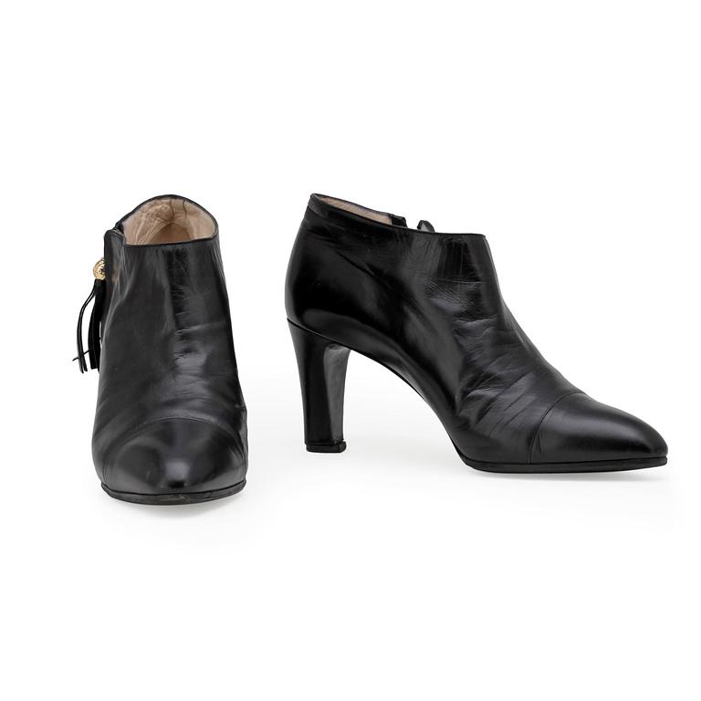 CHANEL, a pair of black leather boots.