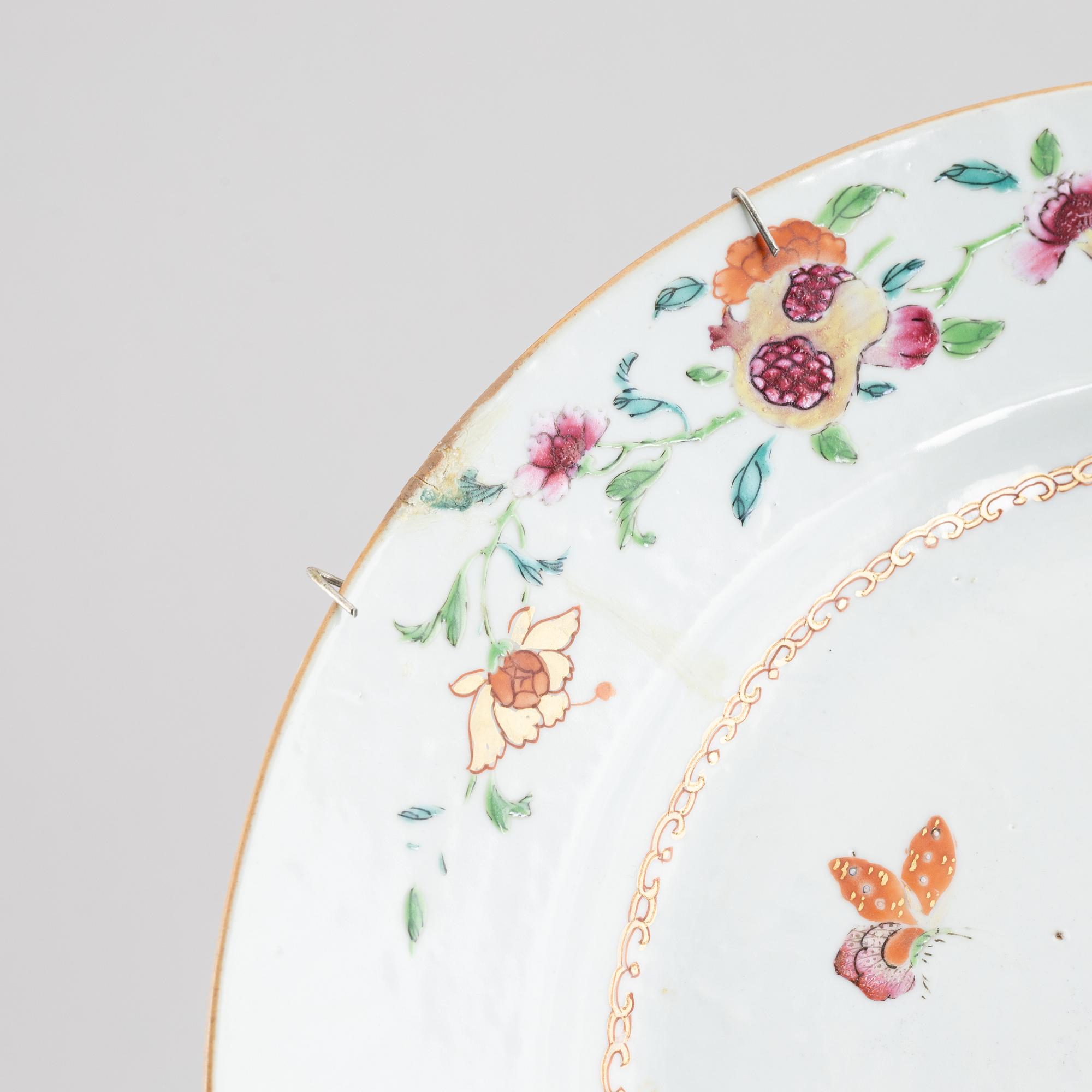 Five Famille rose plates and a charger, China, Qianlong (1736-95).