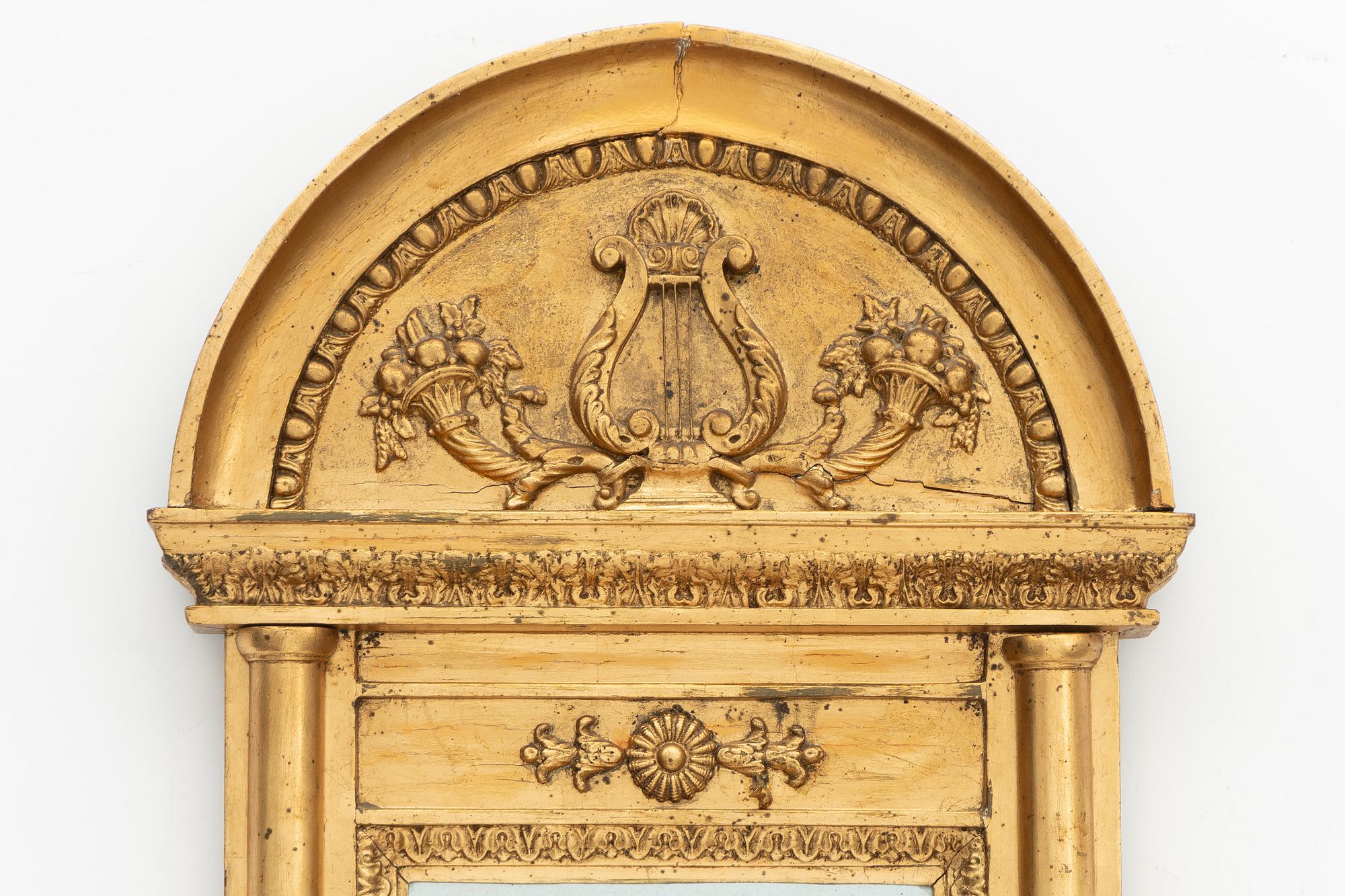 An Empire mirror, early 19th Century.