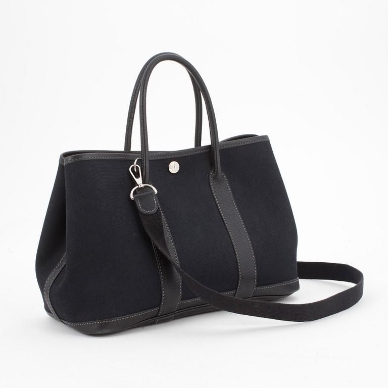 HERMÈS, a black canvas and leather bag, "Garden Party".