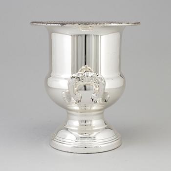 A 20TH CENTURY SILVERVED METAL CHAMPAGNE COOLER.