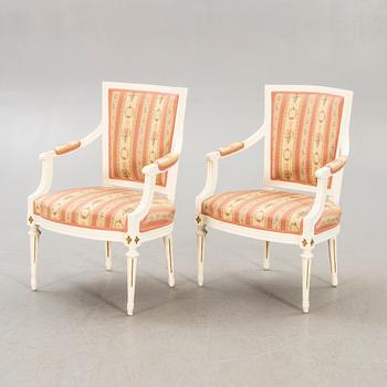A pair of Swedish painted late Gustavian armchairs around 1800.