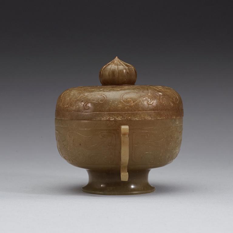 A carved archaistic nephrite bowl with cover decorated with taotie-masks, China, 20th Century.