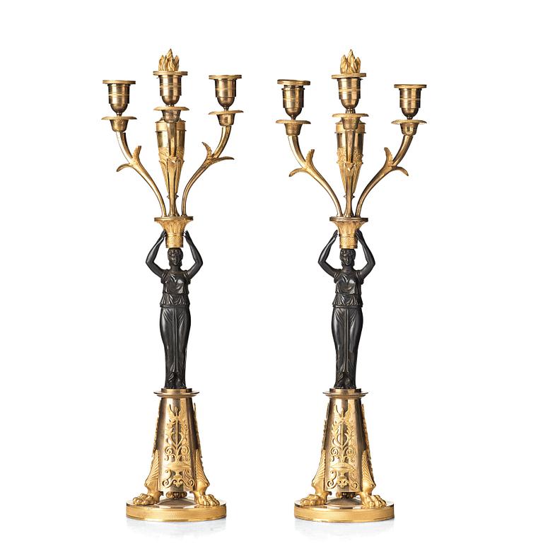 A pair of French Empire early 19th century three-light candelabra.