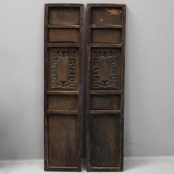 A pair of Chinese red lacquered wooden panels, 20th century.