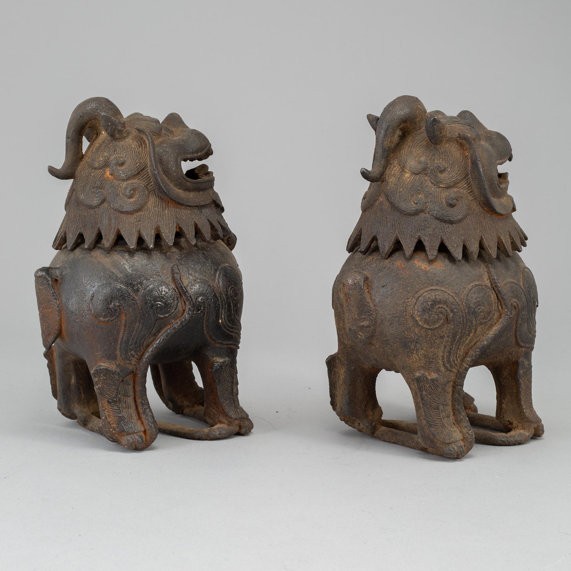 A pair of Chinese iron Fo dogs, 20th Century.