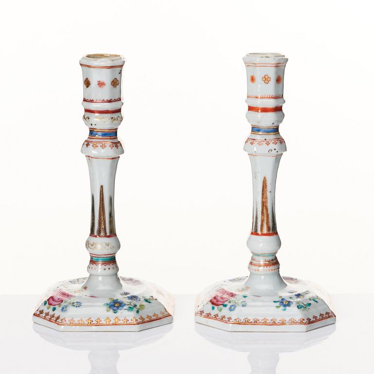 A pair of famille rose candles sticks, Qing dynasty, Qianlong (1736-95).