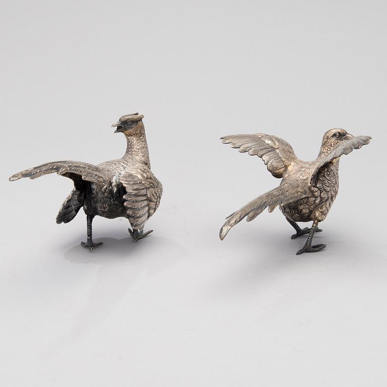 Two bird table decorations in silver, German and British hallmarks.