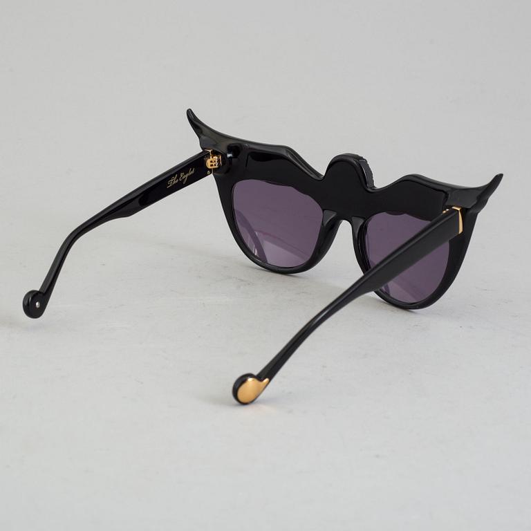 A pair of Anna-Karin Karlsson sunglasses.