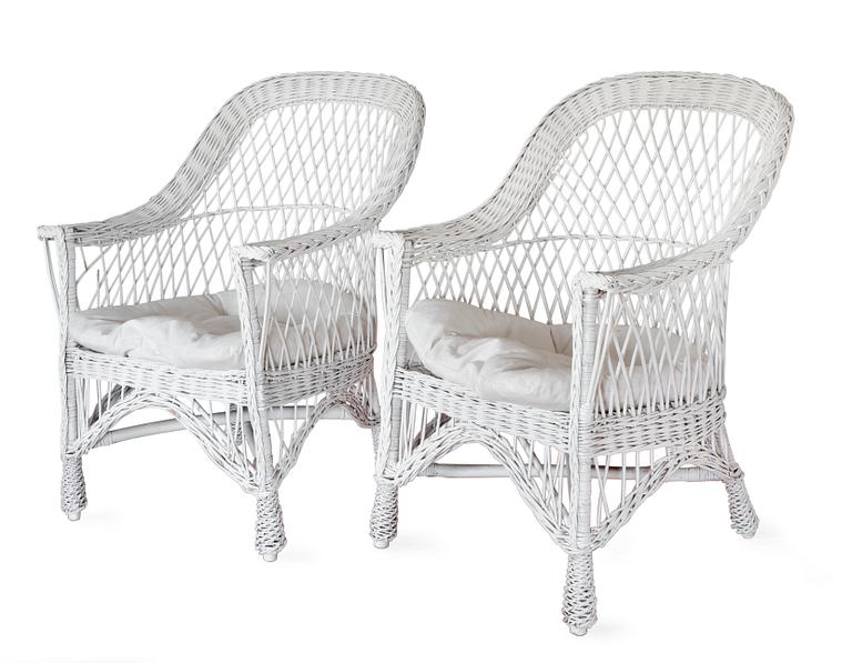A PAIR OF WHITE WICKER ARMCHAIRS,