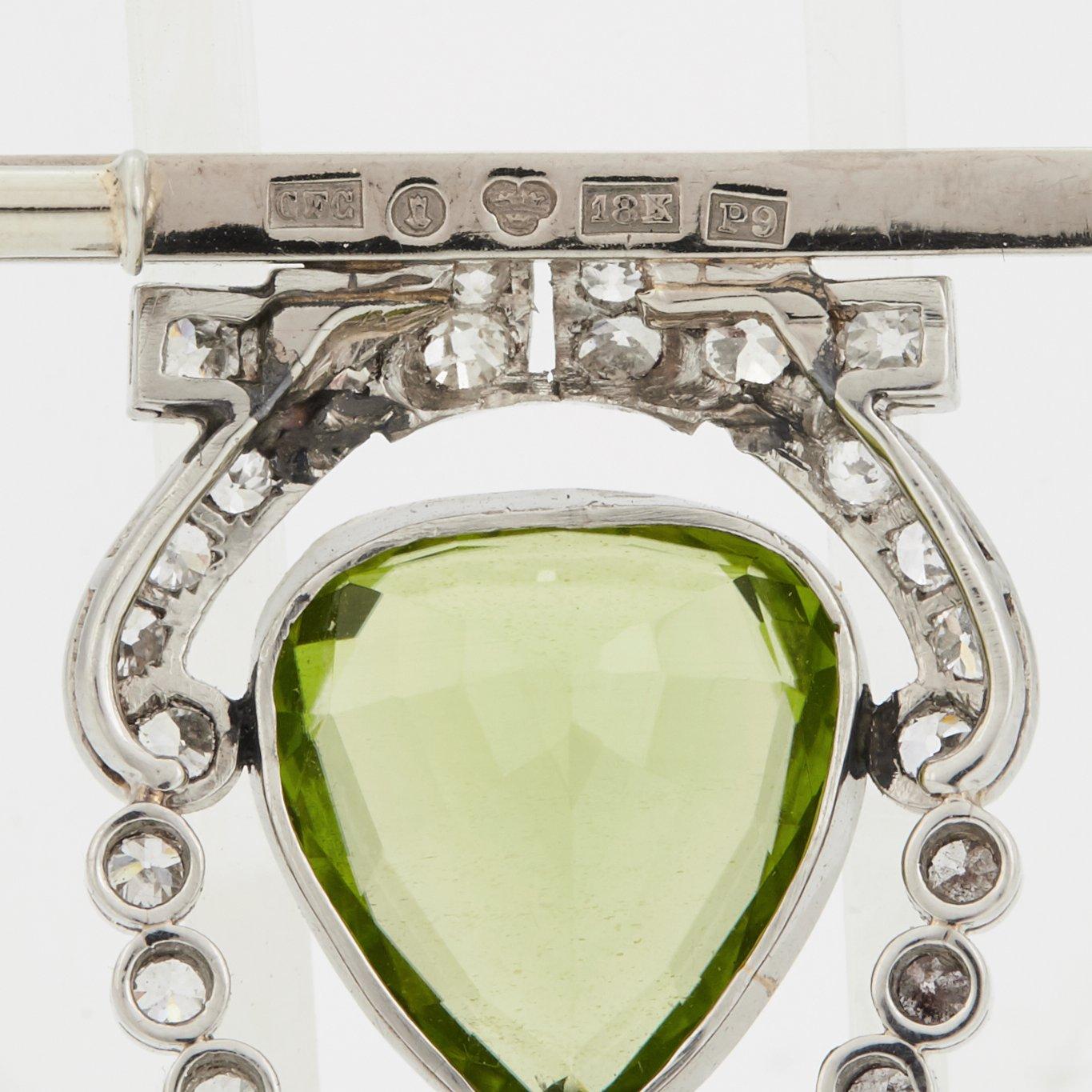 BROSCH med en droppformad fasettslipad peridot samt gammalslipade diamanter.