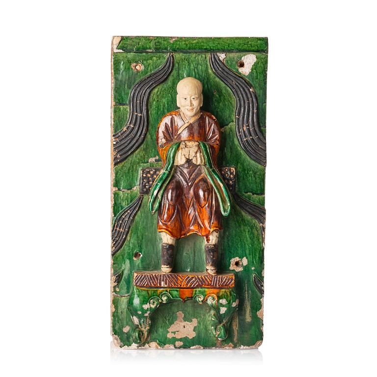A green and yellow glazed architectural element with a Lohan, Ming dynasty (1368-1644), dated 1536.