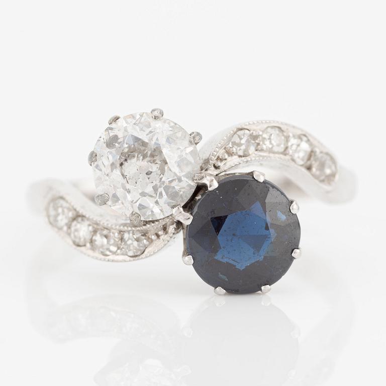 Ring, sibling ring, 18K white gold with dark sapphire and diamonds.