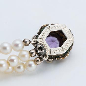 A cultured saltwater pearl collier with silver lock with purple faceted amethyst.