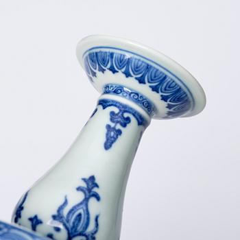 A pair of blue and white pricket candle sticks, with a poem, Qing dynasty with a Qianlong mark and of the period.