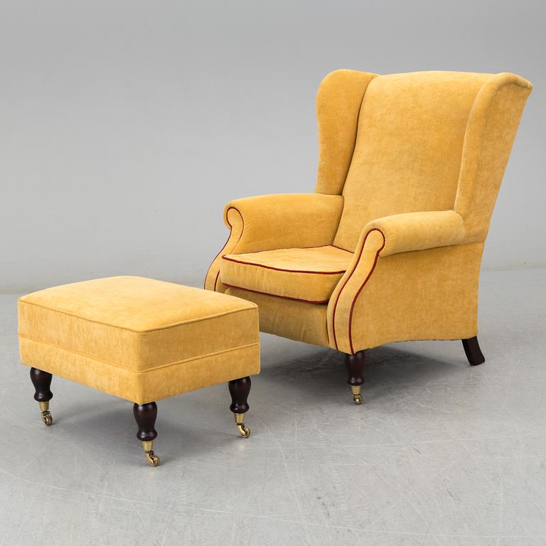 A 'York Wing Chair' easy chair with foot stool from Parker Knoll, 21st Century.