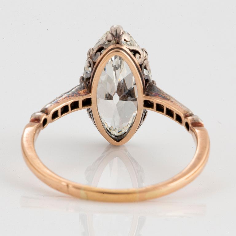 A 14K gold and silver ring set with a navette-cut diamond with a total weight of ca 2.75 cts quality ca K vs.