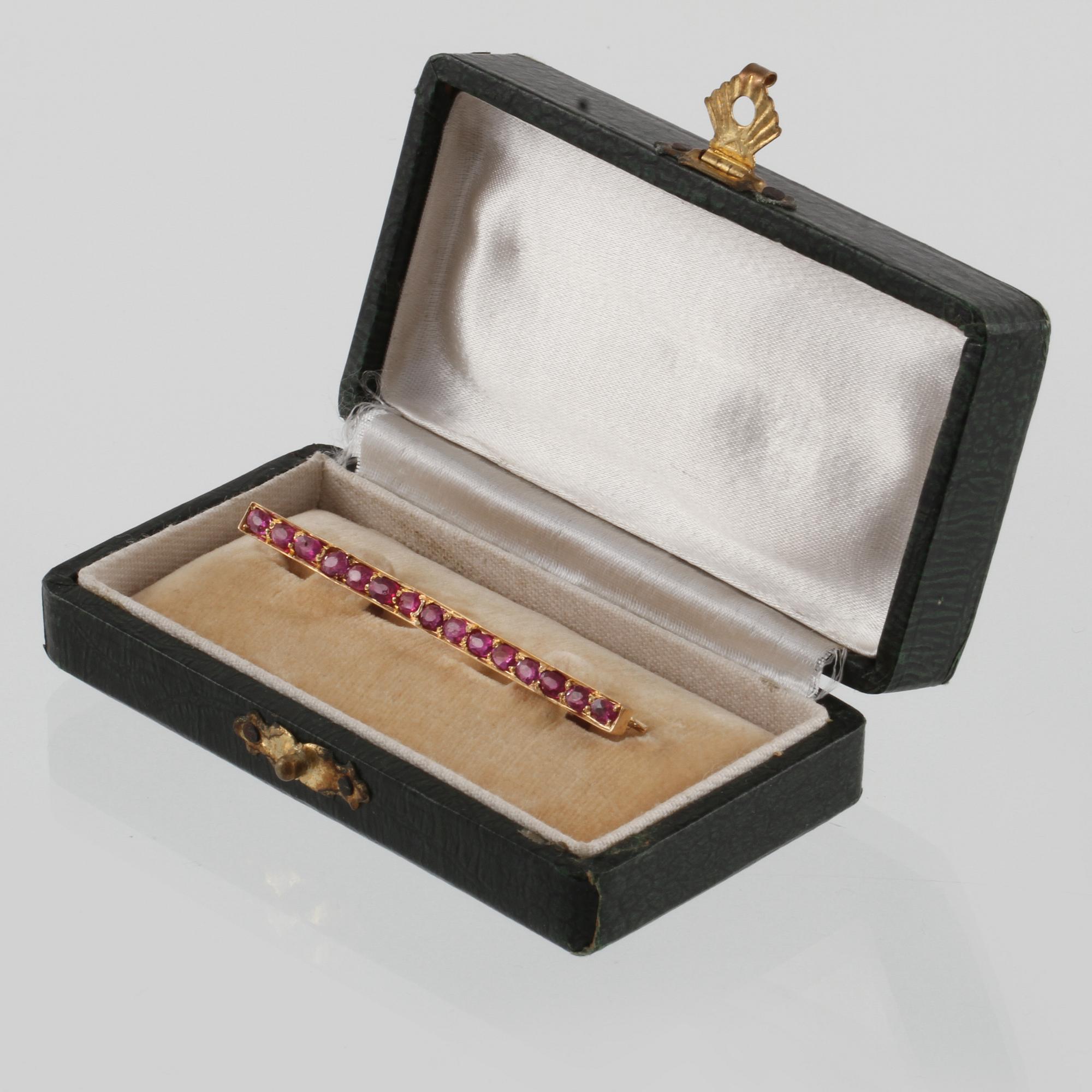 BROSCH, 18K guld med 15 fasettslipade rubiner. Vikt 4,8 gram.