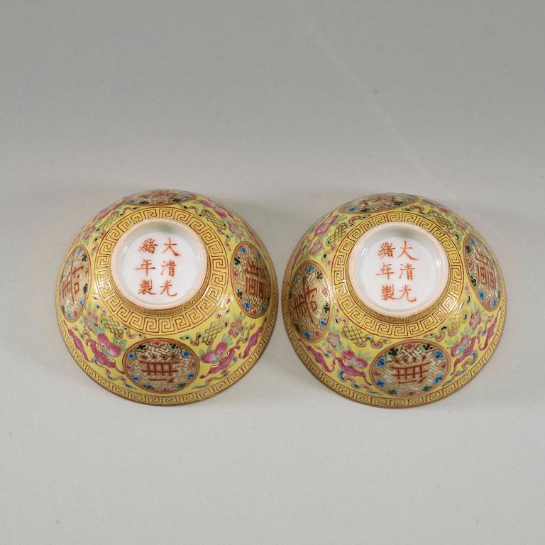 A pair of famille rose yellow ground cups, Qing dynasty, Guangxu six-character mark and of the period  (1875-1908).