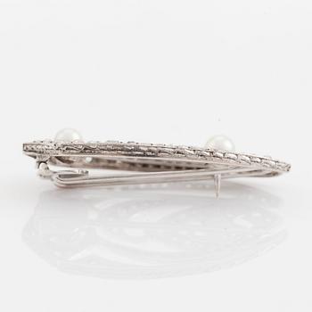 A silver brooch set with old- and rose-cut diamonds and pearls.