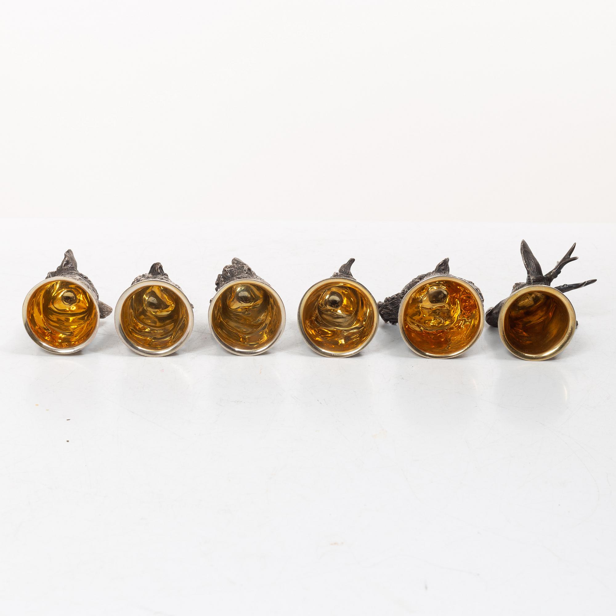 Six Russian parcel-gilt silver animal's head stirrup cups, including with mark of Nikols & Plinke, St. Petersburg.
