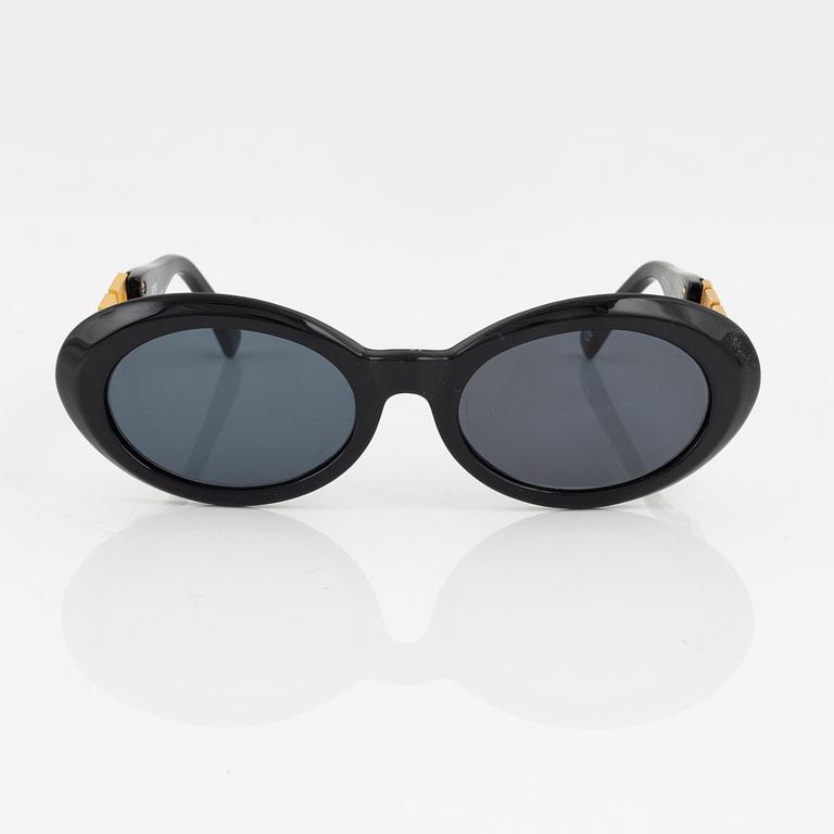 Gianni Versace, a pair of black and gold sunglasses.